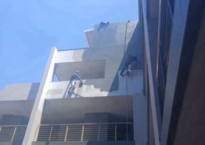 Concrete spalling repairs on high-rise building facade by rope access contractors in Durban